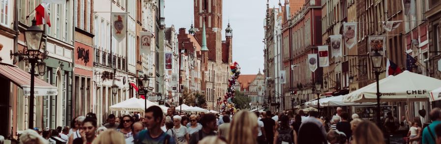 People walking through a street with European architecture