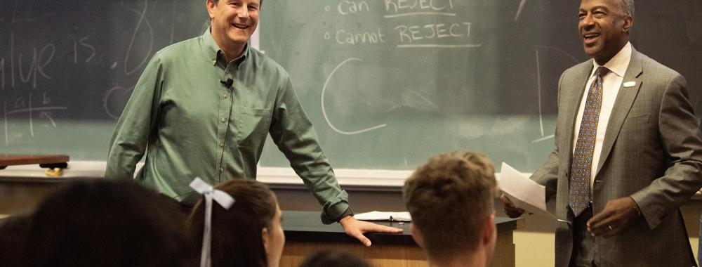 Professor Jay Stachowicz being told by Chancellor May of his teaching award while he was lecturing students. 