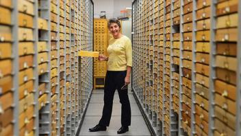 Professor Emerita Lynn Kimsey walking down a row lined with people carrying bug catcher nets. 