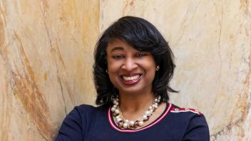 VC Renetta Garrison Tull standing by a granite wall. 