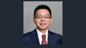A headshot of Professor Junshan Zhang wearing a blue suit, white collar shirt, and a red tie. 